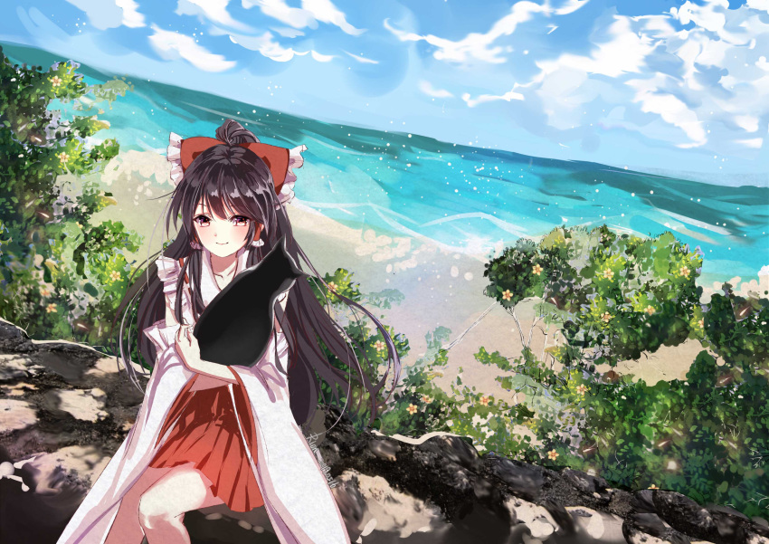 1girl absurdres artist_name bangs black_cat black_hair blush bow cat closed_mouth clouds cloudy_sky commentary_request dated day detached_sleeves eyebrows_visible_through_hair frilled_bow frills hair_between_eyes hair_bow hair_tubes hakurei_reimu highres holding long_hair long_sleeves looking_at_viewer nontraditional_miko outdoors pleated_skirt red_bow red_eyes red_shirt red_skirt ribbon_trim shirt sidelocks signature sitting skirt sky sleeveless sleeveless_shirt smile solo touhou tree very_long_hair vioro water waves wide_sleeves