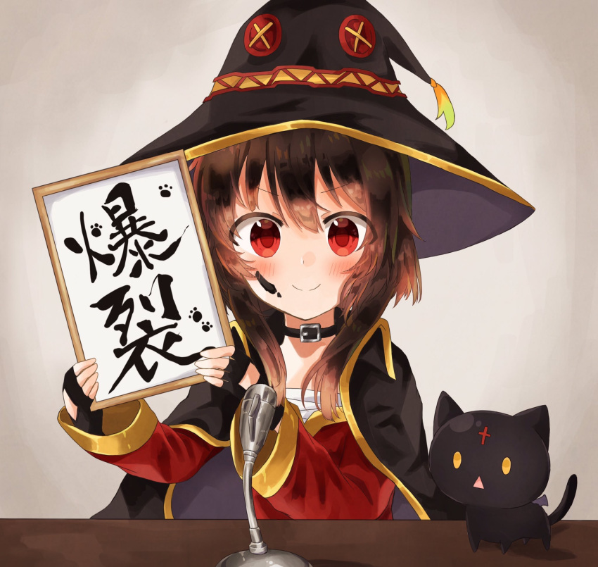 1girl black_cat blush brown_hair calligraphy cape cat chomusuke collar fingerless_gloves gloves hat highres holding ink_on_face kono_subarashii_sekai_ni_shukufuku_wo! looking_at_viewer megumin microphone red_eyes reiwa short_hair_with_long_locks translated witch_hat yuno_(suke_yuno)