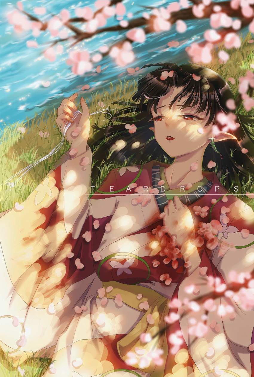 1girl absurdres black_hair blurry cherry_blossoms commentary_request depth_of_field earrings grass highres inuyasha japanese_clothes jewelry kagura_(inuyasha) kimono lying obi on_back pointy_ears red_eyes sash short_hair solo teardrops_(user_vgvd7733) water