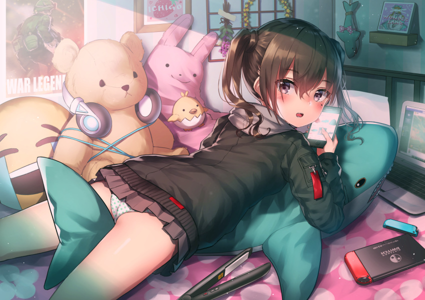 1girl ass bed black_jacket blush brown_hair brown_skirt cable cellphone computer cowboy_shot emoji from_behind headphones highres holding holding_phone hood hooded_jacket idolmaster idolmaster_cinderella_girls indoors jacket long_sleeves looking_at_viewer looking_back lying microskirt mole mole_under_eye nintendo_switch on_stomach open_mouth panties phone picture_frame pleated_skirt polka_dot polka_dot_panties poster_(object) pyonsuke_(pyon2_mfg) shadow sharp_teeth short_hair skirt smartphone solo stuffed_animal stuffed_bird stuffed_bunny stuffed_shark stuffed_toy sunazuka_akira teddy_bear teeth thighs twintails underwear violet_eyes white_panties