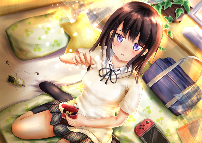 1girl bag black_hair blue_eyes blush book bookbag digital_media_player dutch_angle food from_above hair_ornament hairclip highres kneehighs looking_at_viewer medium_hair nintendo_switch original pillow plaid plaid_skirt plant pocky potted_plant school_uniform short_sleeves sitting skirt solo tissue_box wariza