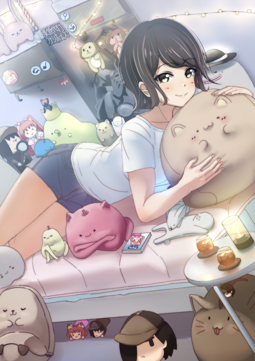 1girl absurdres ajapar badge black_hair blue_shorts button_badge denim denim_shorts doll dutch_angle green_eyes highres indoors looking_at_viewer lying magnifying_glass manga_(object) on_bed on_stomach original shirt shorts smile stuffed_animal stuffed_cat stuffed_dog stuffed_toy white_shirt