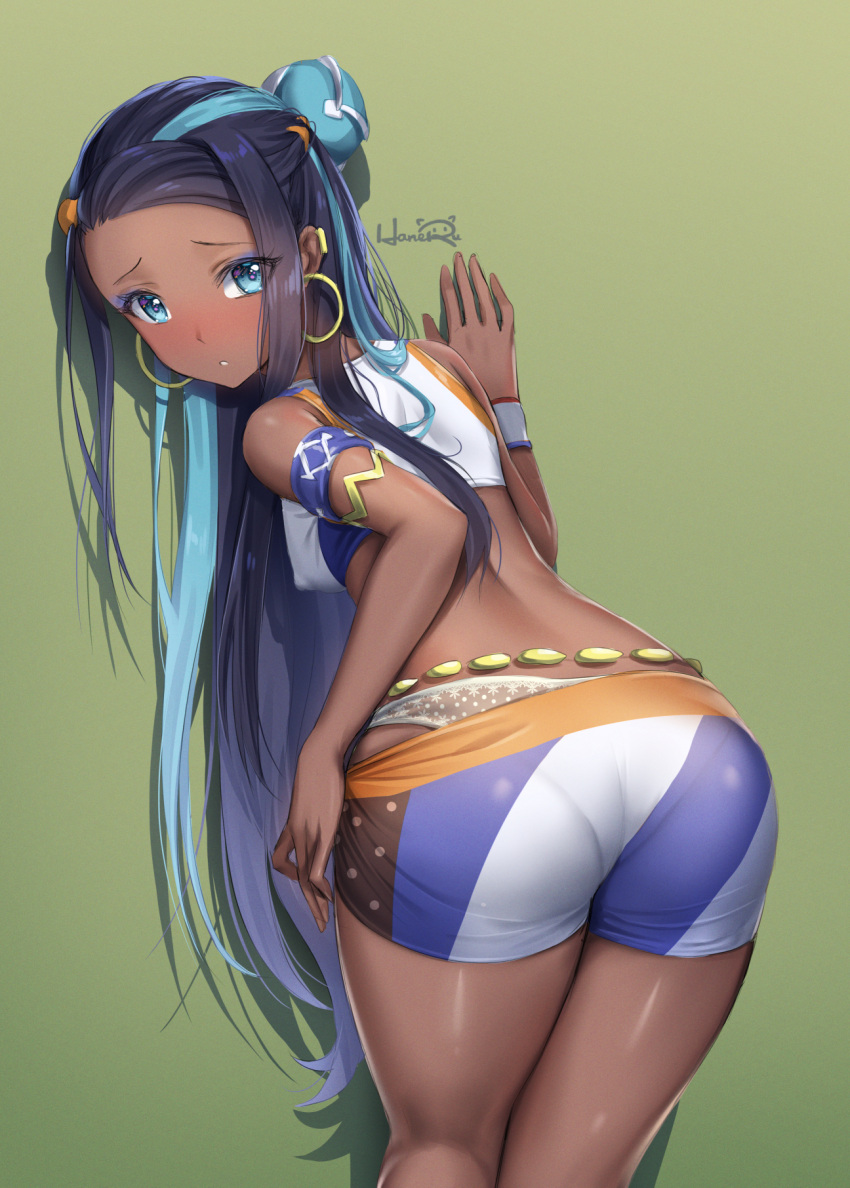 1girl :o arm_strap armlet artist_name ass bare_shoulders bike_shorts black_hair blue_eyes blue_hair blush breasts covered_nipples cowboy_shot crop_top dark_skin earrings forehead from_behind green_background hair_ornament hairclip haneru highres hoop_earrings jewelry leaning_forward long_hair looking_at_viewer looking_back panties parted_lips pokemon pokemon_(game) pokemon_swsh rurina_(pokemon) shorts shorts_pull simple_background small_breasts solo sweatband thighs underwear white_panties