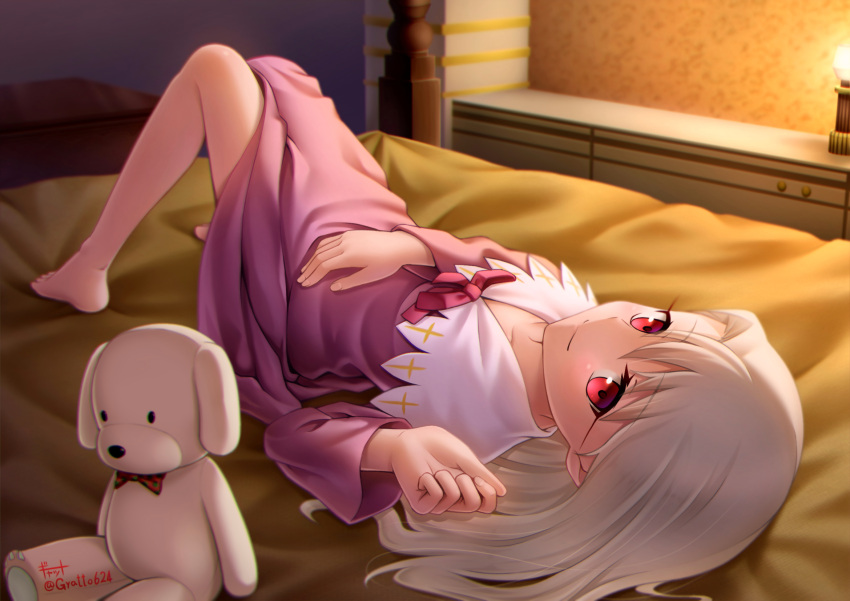 1girl bedroom closed_mouth collarbone dress fate/stay_night fate_(series) from_above full_body gyatto624 highres illyasviel_von_einzbern indoors long_hair long_sleeves looking_at_viewer lying on_back pink_dress red_eyes silver_hair smile solo stuffed_animal stuffed_toy twitter_username