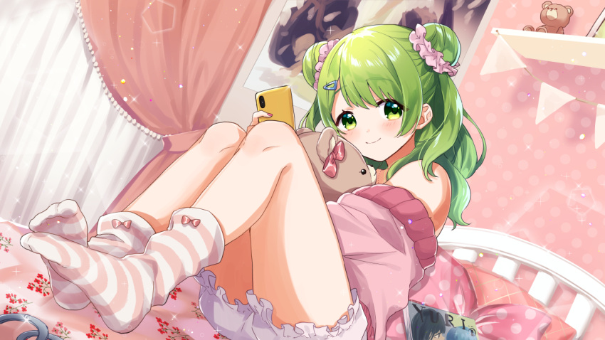 1girl bangs bare_shoulders bed bloomers blush cellphone closed_mouth curtains day double_bun eyebrows_visible_through_hair fingernails glint green_eyes green_hair hair_ornament hair_scrunchie hairclip holding holding_cellphone holding_phone indoors jacket knees_up long_hair morinaka_kazaki nail_polish nijisanji no_shoes off_shoulder on_bed open_clothes open_jacket pennant phone pillow pink_jacket pink_scrunchie poster_(object) red_nails scrunchie shelf sitting smile socks soles solo string_of_flags striped striped_legwear stuffed_animal stuffed_toy teddy_bear underwear virtual_youtuber white_bloomers yamabukiiro