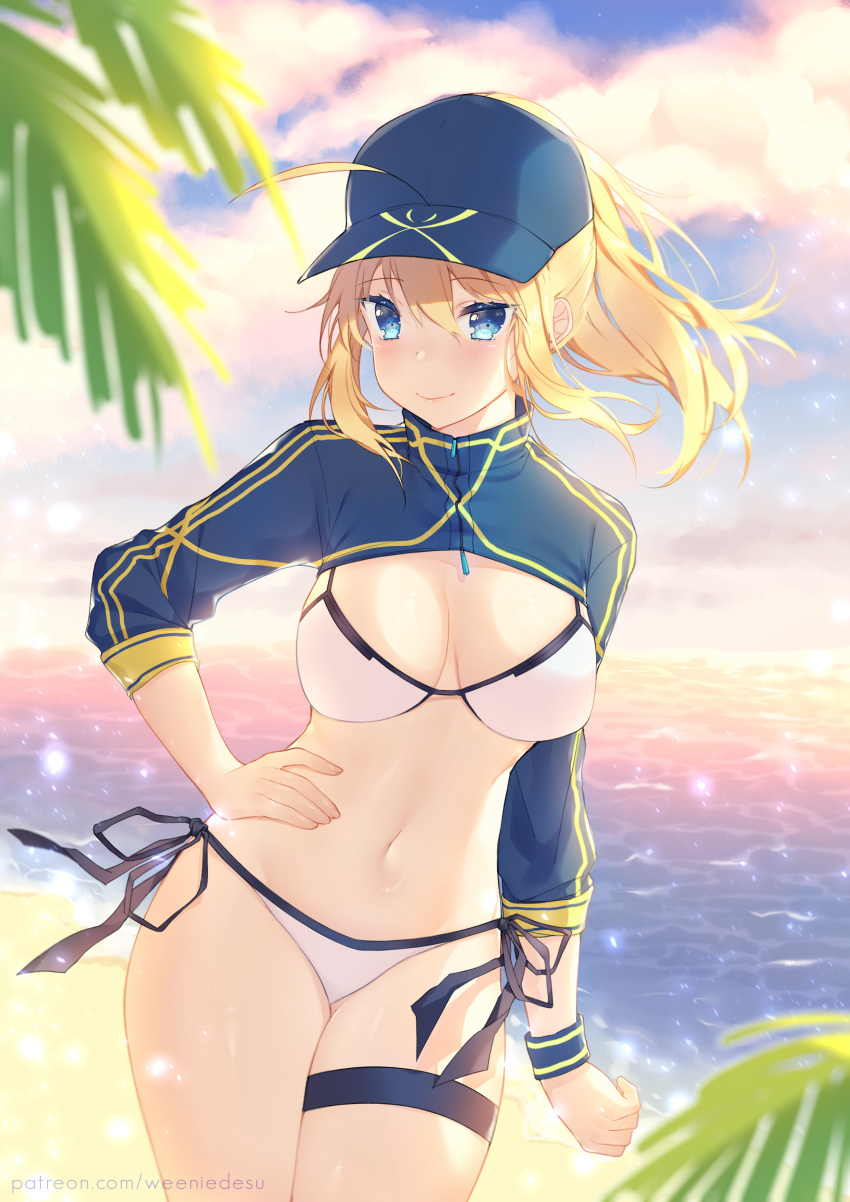 1girl absurdres ahoge artoria_pendragon_(all) baseball_cap beach bikini blonde_hair blue_eyes blue_headwear blue_jacket breasts clouds cowboy_shot cropped_jacket evening fate/grand_order fate_(series) hair_between_eyes hair_through_headwear hand_on_hip hat highres jacket large_breasts mysterious_heroine_xx_(foreigner) navel outdoors ponytail shrug_(clothing) side-tie_bikini smile solo standing swimsuit thigh_strap weeniedesu white_bikini wristband zipper_pull_tab