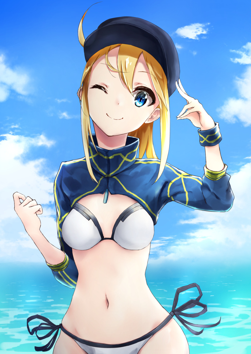1girl absurdres ahoge artoria_pendragon_(all) baseball_cap bikini blonde_hair blue_eyes blue_headwear breasts commentary_request day fate/grand_order fate_(series) hair_between_eyes hair_through_headwear hat highres large_breasts long_hair looking_at_viewer mayume_(polaris_quaver) mysterious_heroine_xx_(foreigner) navel one_eye_closed outdoors ponytail shrug_(clothing) side-tie_bikini solo swimsuit thigh_strap water white_bikini