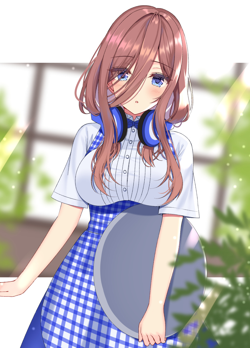 1girl :o absurdres apron bangs blue_eyes blue_skirt blurry blurry_background blurry_foreground blush breasts brown_hair collared_shirt commentary_request depth_of_field dress_shirt dutch_angle eyebrows_visible_through_hair gingham go-toubun_no_hanayome hair_between_eyes headphones headphones_around_neck highres holding holding_tray izumo_neru large_breasts long_hair looking_at_viewer nakano_miku parted_lips shirt short_sleeves skirt solo tray uniform waitress white_shirt