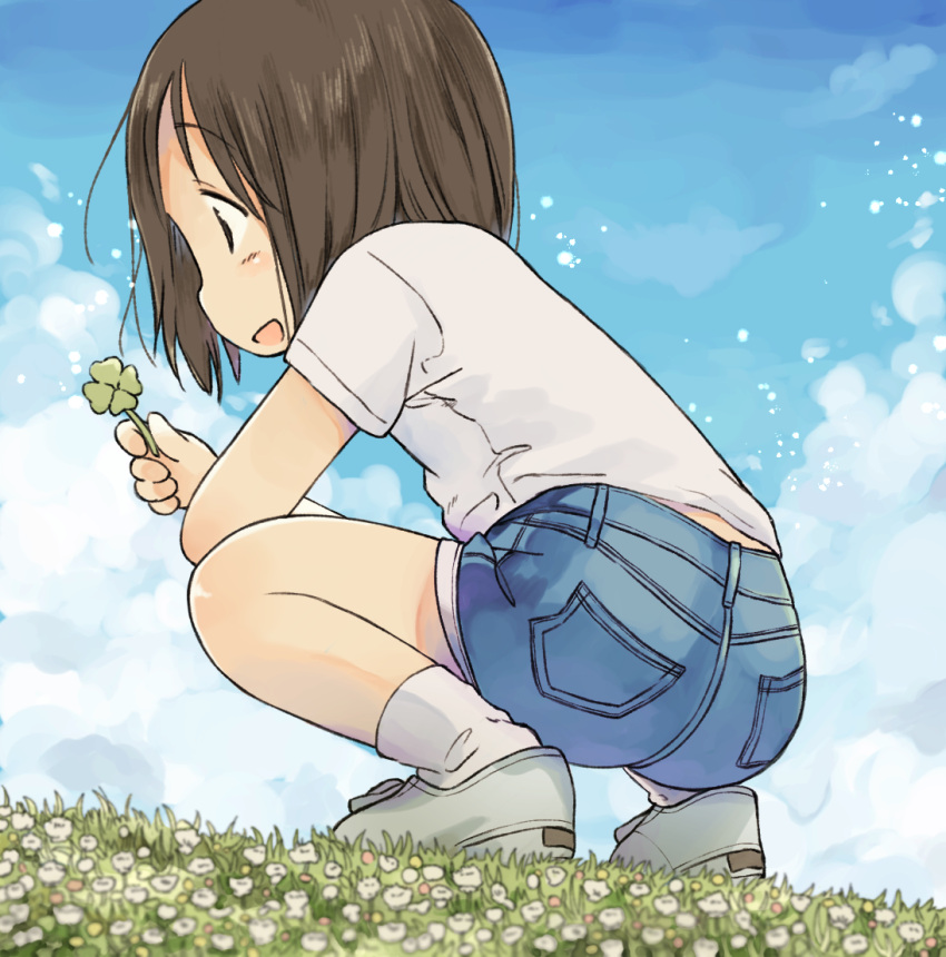 1girl blue_sky blush brown_hair clover denim denim_shorts eyebrows_visible_through_hair four-leaf_clover from_behind from_below holding looking_away nanoningen_(anapoko) open_mouth original outdoors short_hair shorts sideways_mouth sky smile solo squatting