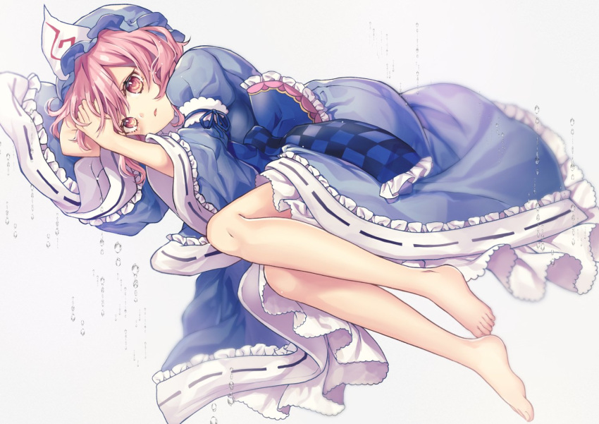 1girl arm_garter arm_up bangs barefoot blue_dress blue_headwear blush checkered commentary_request dress eyebrows_visible_through_hair frilled_sleeves frills grey_background hand_up hat juliet_sleeves kyouda_suzuka long_sleeves looking_at_viewer lying mob_cap on_side parted_lips petticoat pink_eyes pink_hair puffy_sleeves saigyouji_yuyuko short_hair simple_background solo touhou triangular_headpiece water wide_sleeves