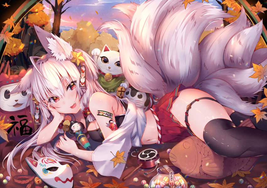 1girl animal_ear_fluff animal_ears autumn autumn_leaves black_legwear cat commentary_request dango falling_leaves food fox_ears fox_girl fox_mask fox_tail holding holding_food leaf long_hair lying maneki-neko maple_leaf mask mask_removed midriff multiple_tails nature navel off_shoulder on_side original outdoors pleated_skirt red_eyes red_skirt silver_hair skewer skirt solo statue tail thigh-highs thigh_strap tomoe_(symbol) tree usagihime wagashi