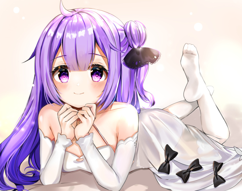 1girl ahoge azur_lane bangs bare_shoulders bed_sheet black_bow black_ribbon blush bow closed_mouth collarbone commentary_request criss-cross_halter detached_sleeves dress eyebrows_visible_through_hair full_body hair_between_eyes hair_bun hair_ribbon halterneck katsushika_pachi legs_up long_hair long_sleeves lying no_shoes on_stomach one_side_up purple_hair ribbon see-through side_bun smile soles solo thigh-highs unicorn_(azur_lane) violet_eyes white_dress white_legwear white_sleeves