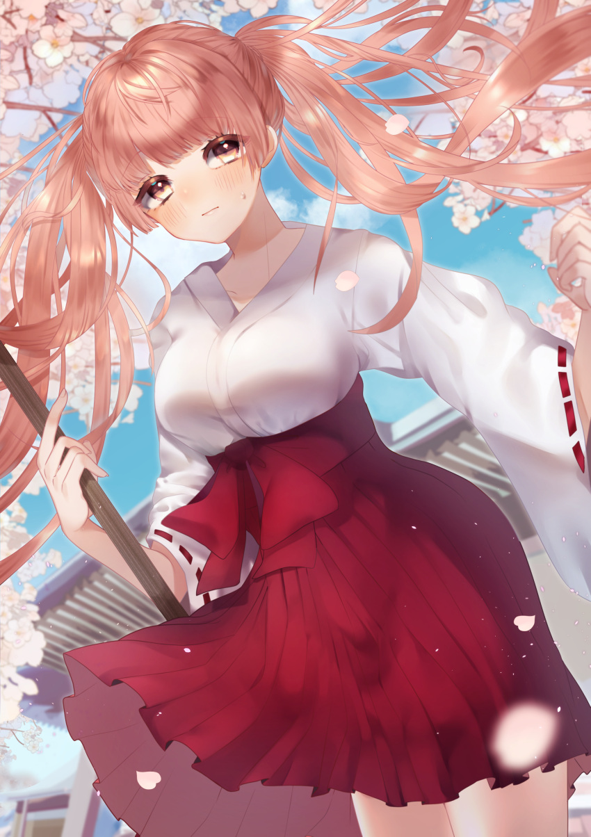 1girl absurdres architecture ayamon_168_(yiwei) blue_sky breasts broom brown_hair cherry_blossoms clouds day east_asian_architecture hakama hand_up highres holding holding_broom japanese_clothes large_breasts long_hair miko original outdoors petals red_hakama ribbon-trimmed_sleeves ribbon_trim sky solo standing twintails wide_sleeves