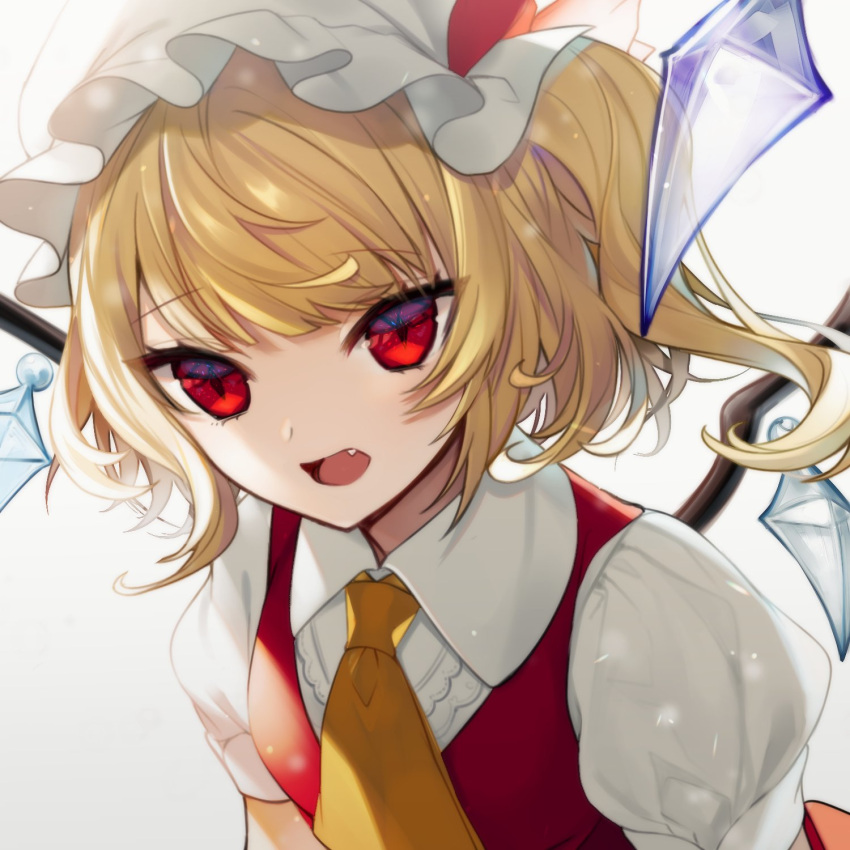 1girl ascot bangs blonde_hair bow commentary_request crystal daimaou_ruaeru eyebrows_visible_through_hair fang flandre_scarlet grey_background hat hat_bow highres looking_at_viewer mob_cap one_side_up open_mouth puffy_short_sleeves puffy_sleeves red_bow red_eyes red_vest shirt short_hair short_sleeves simple_background solo touhou upper_body vest white_headwear white_shirt wings yellow_neckwear