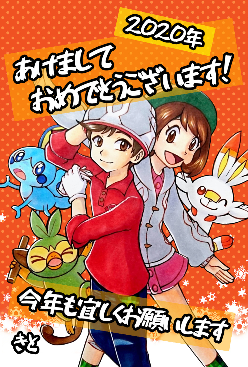 &gt;_&lt; 1boy 1girl 2020 :d blue_eyes brown_eyes creature dress gen_8_pokemon green_headwear grookey hapy_new_year highres holding long_sleeves mew_holic nengajou new_year one_eye_closed open_mouth orange_background pink_dress pokemon pokemon_special polka_dot polka_dot_background scorbunny shirt short_dress smile sobble standing tate_shirudomiria translation_request tsurugi_soudo