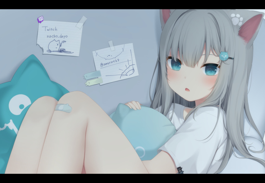 1girl amashiro_natsuki animal_ears bandaid bandaid_on_knee bangs blue_eyes blush cat_ears cat_pillow commentary eyebrows_visible_through_hair grey_hair hair_between_eyes hair_ornament hairclip knees_up letterboxed long_hair looking_at_viewer nacho_(amashiro_natsuki) original parted_lips shirt short_sleeves solo twitch_username twitter_username white_shirt