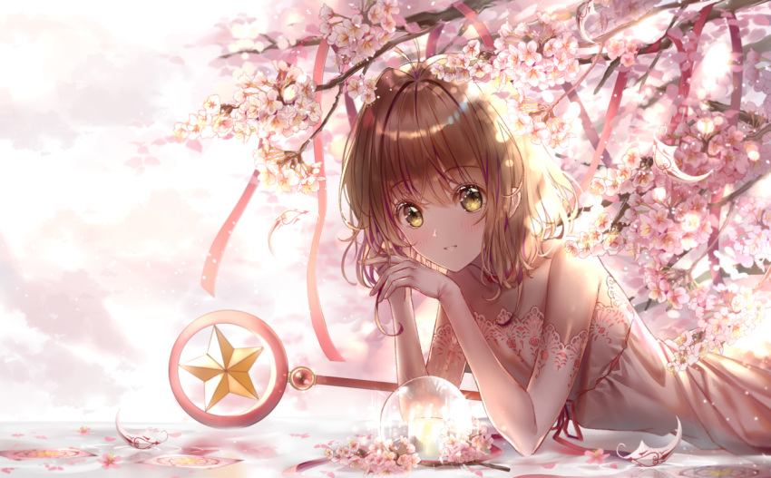 1girl antenna_hair bangs blush brown_hair cardcaptor_sakura cherry_blossoms collarbone dress elbow_gloves eyebrows_visible_through_hair flower gloves hair_between_eyes hair_intakes kinomoto_sakura lium looking_at_viewer lying medium_hair on_stomach parted_lips pink_dress pink_gloves print_dress print_gloves shiny shiny_hair sleeveless sleeveless_dress smile solo staff strapless strapless_dress white_flower yellow_eyes