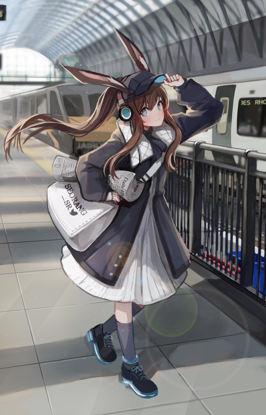 1girl absurdres adjusting_clothes adjusting_hat alternate_costume amiya_(arknights) animal_ears arknights arm_up bag bangs baseball_cap black_footwear black_headwear black_jacket blue_eyes blush brown_hair commentary_request dress floating_hair grey_footwear ground_vehicle hair_between_eyes hat head_tilt headphones highres holding holding_newspaper jacket kneehighs lens_flare long_hair long_sleeves looking_at_viewer newspaper pn_pixi ponytail rabbit_ears railing satchel shoes smile sneakers solo train train_station white_dress