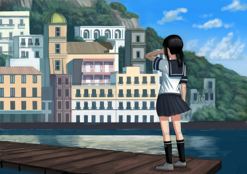 1girl architecture black_hair black_legwear black_skirt building city clouds cloudy_sky commentary_request day from_behind fubuki_(kantai_collection) hand_on_own_face highres house kantai_collection kneehighs medium_hair mountain pier ponytail scenery school_uniform serafuku shirt shoes sidelocks skirt sky solo standing wasabi60 water white_shirt