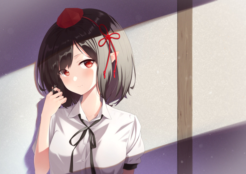 1girl bangs black_hair black_neckwear black_ribbon blush commentary hand_up hat head_tilt highres indoors kanpa_(campagne_9) looking_at_viewer neck_ribbon pointy_ears puffy_short_sleeves puffy_sleeves red_eyes ribbon shadow shameimaru_aya shirt short_hair short_sleeves sidelocks solo tokin_hat touhou upper_body white_shirt