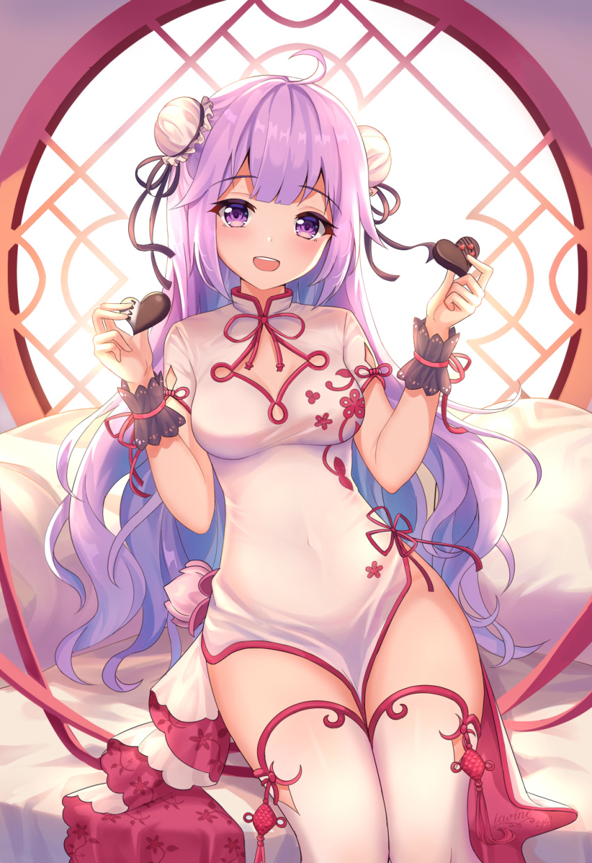 1girl :d ahoge aisuuwan azur_lane backlighting bangs bed_sheet blush breasts bun_cover candy china_dress chinese_clothes chocolate chocolate_heart commentary_request day double_bun dress eyebrows_visible_through_hair food heart highres holding holding_food long_hair looking_at_viewer medium_breasts open_mouth pelvic_curtain pillow purple_hair round_window short_sleeves sitting smile solo sunlight thigh-highs unicorn_(azur_lane) unicorn_(spring's_present)_(azur_lane) upper_teeth valentine very_long_hair violet_eyes white_dress white_legwear window wrist_cuffs