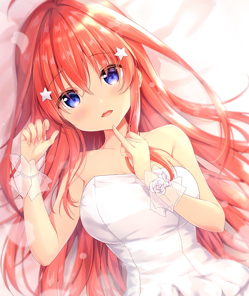 1girl ahoge amedamacon bangs bare_shoulders bed_sheet blue_eyes blurry blurry_background blush bracelet breasts commentary_request depth_of_field dress eyebrows_visible_through_hair flower go-toubun_no_hanayome hair_between_eyes hair_ornament highres jewelry long_hair looking_at_viewer lying medium_breasts nakano_itsuki on_back open_mouth pearl_bracelet redhead rose see-through solo star star_hair_ornament strapless strapless_dress upper_body upper_teeth very_long_hair white_dress white_flower white_rose wrist_cuffs