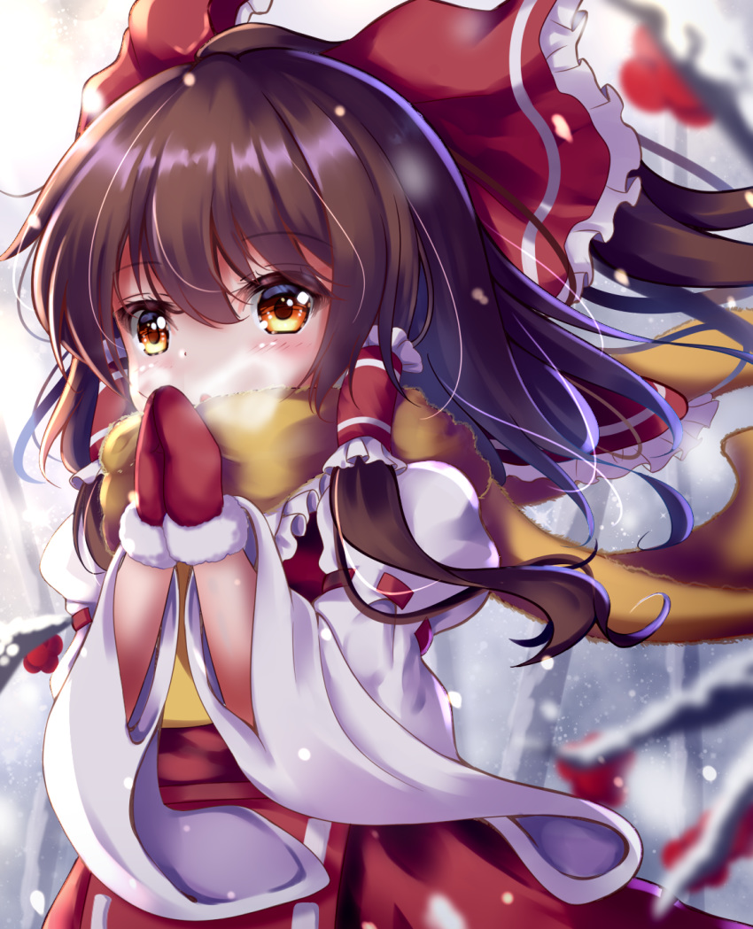 1girl :o adapted_costume bare_tree blurry blurry_background breath breathing_on_hands brown_hair commentary cravat depth_of_field eyebrows_visible_through_hair fur-trimmed_mittens hair_between_eyes hair_blowing hair_tubes hakurei_reimu highres long_hair long_sleeves looking_at_viewer mittens outdoors ponytail red_eyes red_mittens red_skirt red_vest ribbon-trimmed_sleeves ribbon_trim scarf sidelocks skirt skirt_set snowing solo standing touhou tree unory upper_body vest white_sleeves wide_sleeves wind wind_lift winter yellow_neckwear yellow_scarf