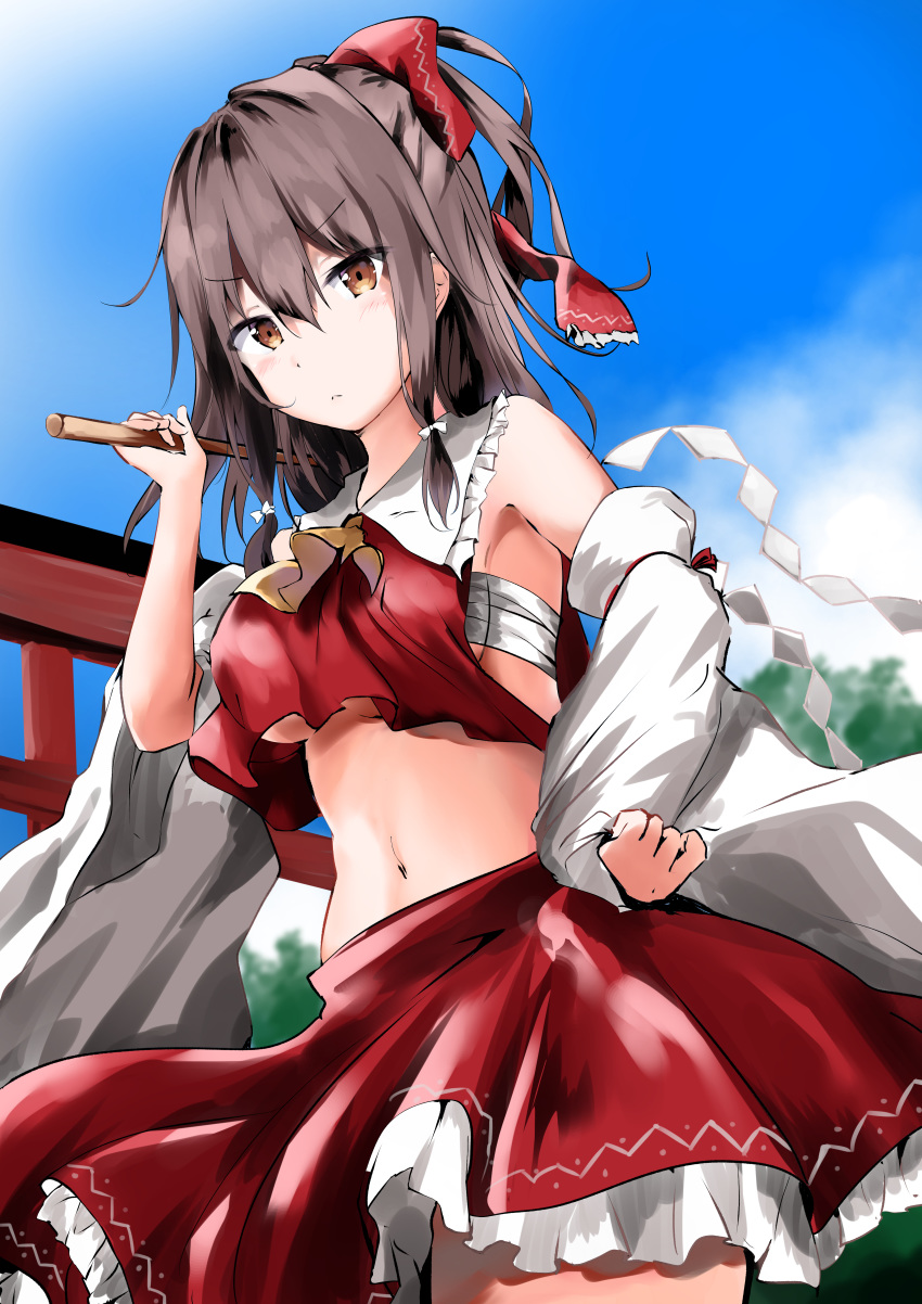 1girl absurdres armpits ascot bare_shoulders bow breasts brown_eyes brown_hair clouds collared_shirt commentary_request cowboy_shot crop_top crop_top_overhang detached_sleeves frilled_shirt_collar frills frown gohei hair_bow hakurei_reimu hand_on_hip hand_up highres holding kuromiko_shoujo long_hair looking_at_viewer medium_breasts midriff miniskirt navel red_shirt red_skirt sarashi shirt skirt sky solo stomach torii touhou under_boob v-shaped_eyebrows wide_sleeves