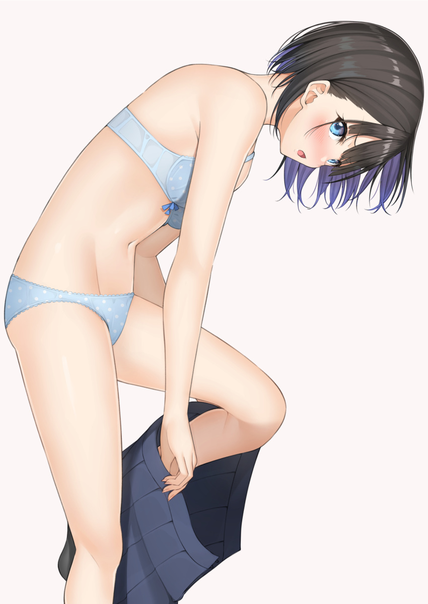 1girl bare_shoulders black_hair blue_bra blue_eyes blue_panties blue_skirt bra commentary_request groin highres leg_up looking_at_viewer miniskirt mottsun_(i_40y) navel open_mouth original panties pleated_skirt polka_dot polka_dot_bra polka_dot_panties short_hair simple_background skirt solo stomach thighs underwear undressing white_background