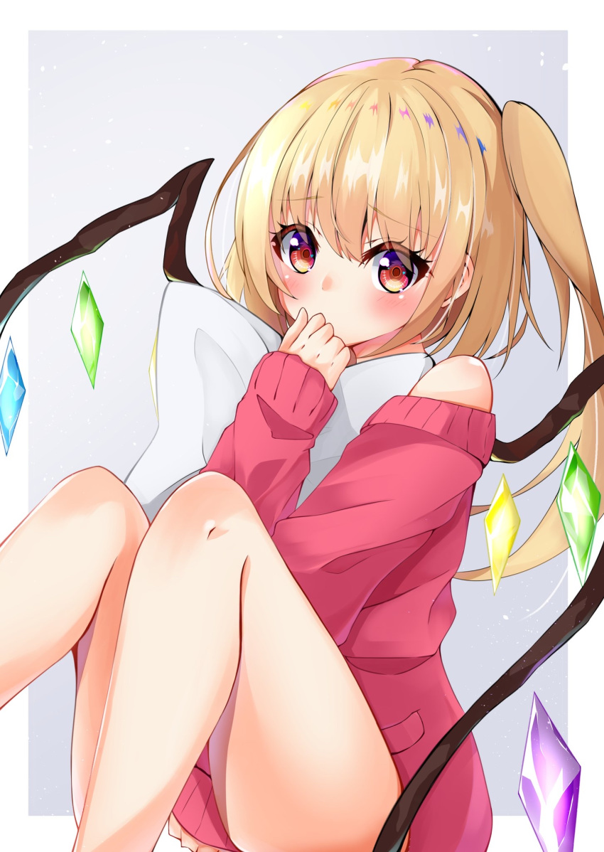 1girl alternate_costume blonde_hair blush commentary covered_mouth crystal ekidona feet_out_of_frame flandre_scarlet grey_background hand_up highres knees_up long_hair looking_at_viewer off-shoulder_sweater off_shoulder pillow pillow_hug raised_eyebrows red_sweater side_ponytail sitting sleeves_past_wrists solo sweater touhou wings