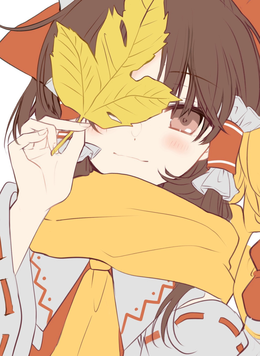 1girl blush brown_eyes brown_hair commentary_request eyebrows_visible_through_hair hair_tubes hakurei_reimu highres holding holding_leaf leaf light_smile looking_at_viewer poprication scarf solo touhou upper_body white_background wide_sleeves yellow_neckwear yellow_scarf