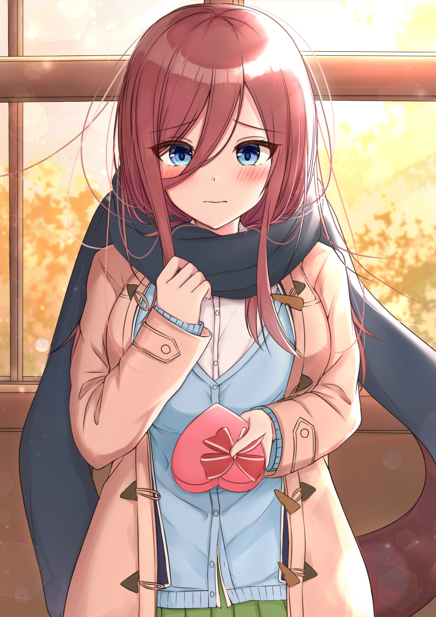 1girl absurdres bangs black_scarf blue_cardigan blue_eyes blush bow box breasts brown_coat brown_hair cardigan closed_mouth coat commentary_request dress_shirt enpera eyebrows_visible_through_hair gift gift_box go-toubun_no_hanayome green_skirt hair_between_eyes heart-shaped_box highres holding holding_gift indoors long_hair long_sleeves looking_at_viewer medium_breasts nakano_miku open_clothes open_coat pleated_skirt red_bow scarf school_uniform shirt skirt sleeves_past_wrists solo valentine white_shirt window yukiunag1