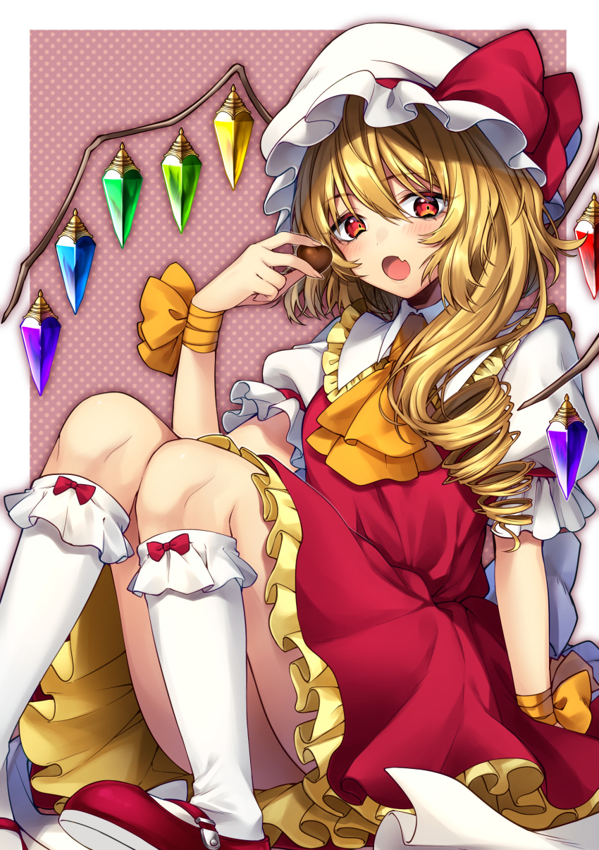 1girl absurdres arm_ribbon ascot bangs blonde_hair blush bow chocolate crystal eyebrows_visible_through_hair fang flandre_scarlet frilled_shirt frilled_shirt_collar frilled_skirt frilled_sleeves frills hat hat_ribbon highres long_hair looking_at_viewer mob_cap one_side_up open_mouth polka_dot polka_dot_background puffy_short_sleeves puffy_sleeves red_bow red_eyes red_ribbon red_skirt red_vest ribbon rom shirt short_sleeves side_ponytail sitting skirt skirt_set solo touhou vest white_shirt wings yellow_neckwear