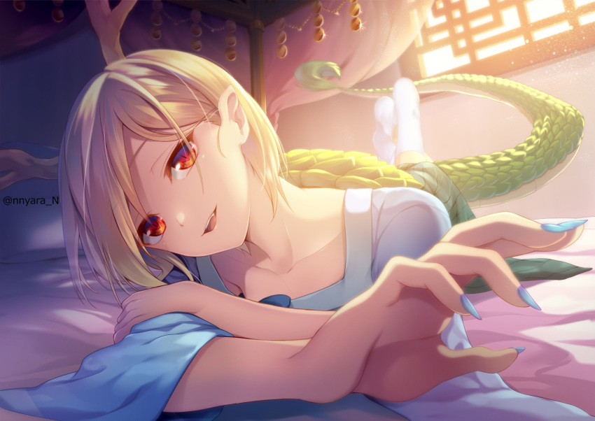 1girl :d artist_name bangs bed_sheet blonde_hair blue_nails blue_shirt collarbone commentary_request dragon_horns dragon_tail eyebrows_visible_through_hair fang fingernails foreshortening green_skirt head_tilt highres horns indoors kicchou_yachie kneehighs long_fingernails long_sleeves looking_at_viewer lying miniskirt nail_polish nnyara no_shoes on_bed on_stomach open_mouth parted_lips red_eyes shirt short_hair skirt slit_pupils smile socks solo swept_bangs tail touhou turtle_shell twitter_username white_legwear window