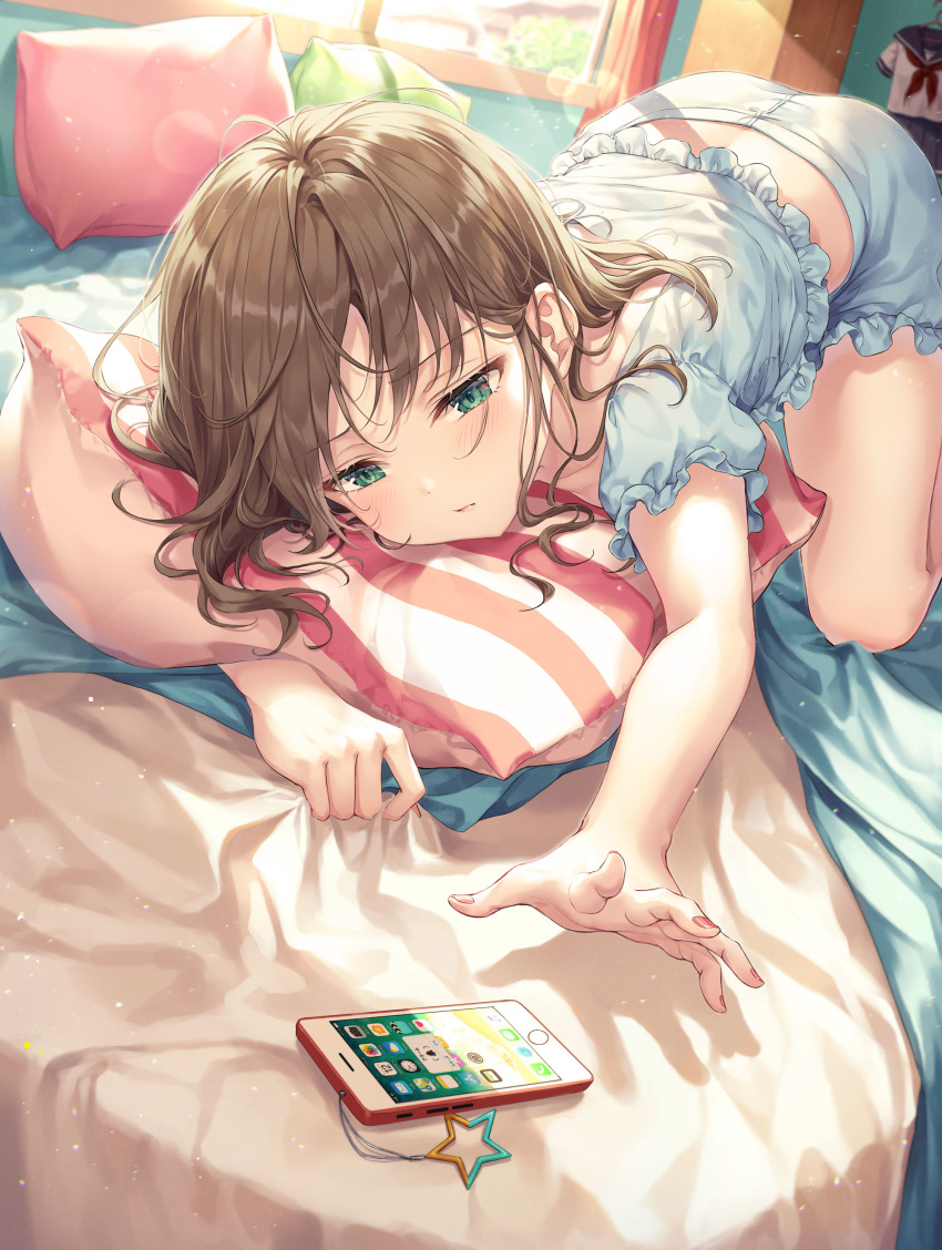 1girl absurdres bed blue_shirt blue_shorts brown_hair cellphone frilled_shirt frills green_eyes highres indoors long_hair loungewear midriff on_bed original outstretched_arm phone pillow r_o_ha reaching_out shirt short_shorts shorts smartphone solo sunlight window