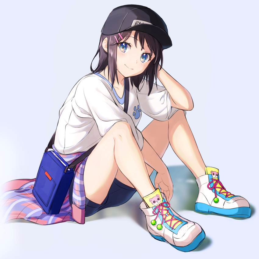 1girl bag bang_dream! bangs bare_legs baseball_cap black_hair black_headwear black_shorts blue_background blue_eyes blush closed_mouth clothes_around_waist commentary_request eyebrows_visible_through_hair full_body gen_(gen_m_gen) hair_ornament hairclip hat highres knees_up looking_at_viewer multicolored_footwear okusawa_misaki paw_print shirt short_hair short_sleeves shorts shoulder_bag simple_background sitting smile solo white_shirt