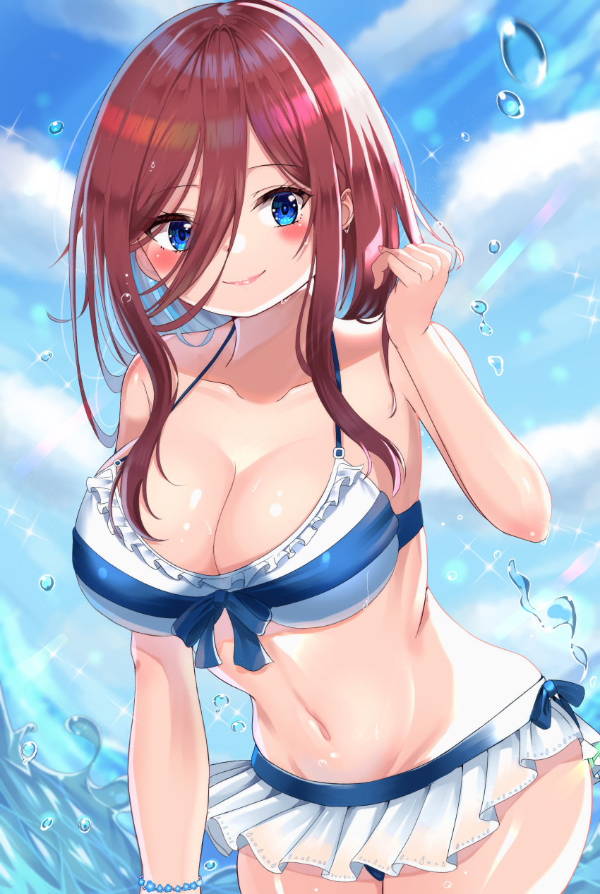 1girl absurdres azumi_(mocha) bikini bikini_skirt blue_bikini_bottom blue_eyes blue_sky blush bow_bikini bracelet breasts brown_hair closed_mouth clouds collarbone day eyebrows_visible_through_hair go-toubun_no_hanayome hair_over_eyes hand_up highres jewelry large_breasts long_bangs looking_at_viewer nakano_miku navel ocean outdoors shiny shiny_skin sidelocks sky smile solo standing summer swimsuit thighs water water_drop white_bikini_top