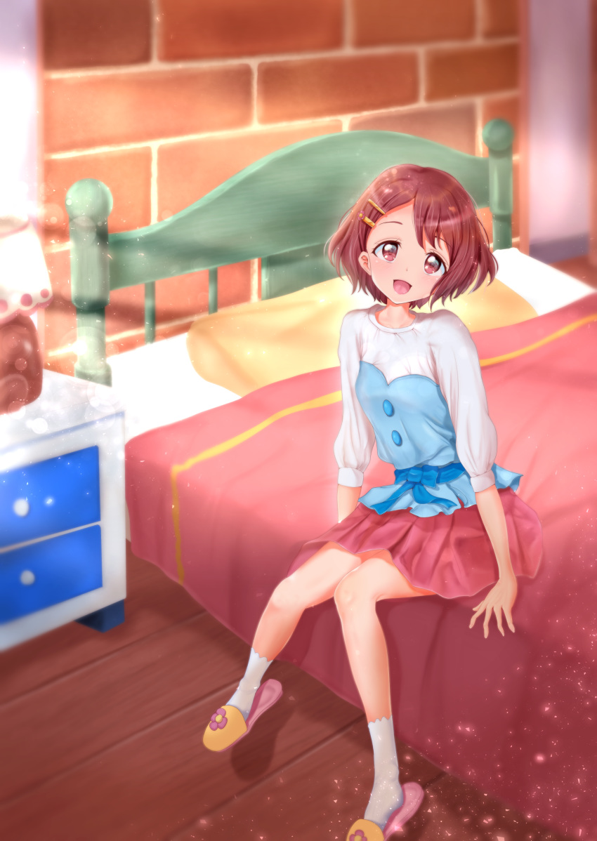 1girl :d absurdres bed bed_sheet flower hair_flower hair_ornament hanadera_nodoka healin'_good_precure highres indoors looking_at_viewer mitaka on_bed open_mouth pillow pink_eyes pink_hair pink_skirt precure short_hair sitting sitting_on_bed skirt slippers smile solo