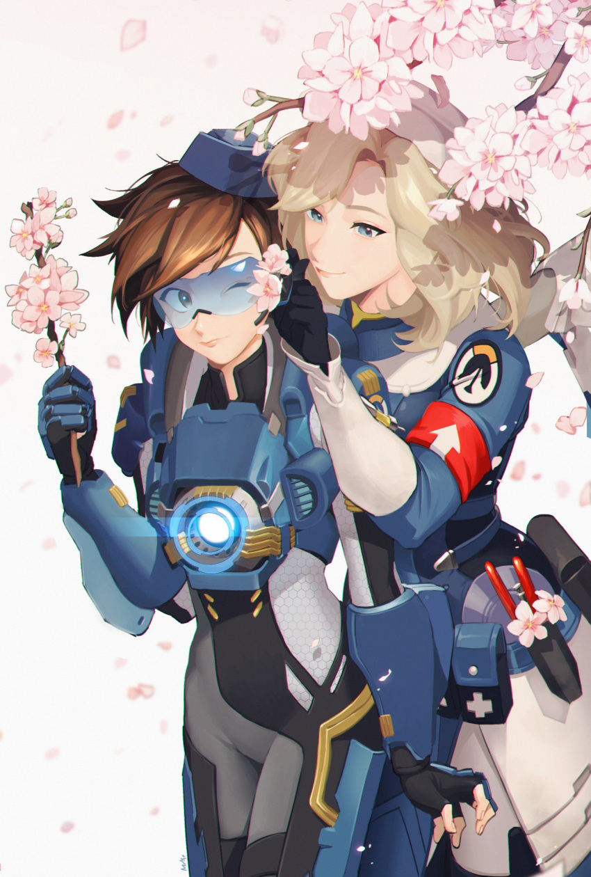 2girls absurdres alternate_costume bangs black_gloves blonde_hair blue_eyes blue_headwear blush bodysuit breasts brown_hair cadet_oxton cherry_blossoms closed_eyes closed_mouth combat_medic_ziegler commentary commentary_request cross fingerless_gloves flower gloves goggles harness hat highres holding holding_stick korean_commentary lips logo long_sleeves looking_at_another maro_(lij512) mechanical_wings mercy_(overwatch) multiple_girls overwatch parted_lips short_hair smile spiky_hair standing tracer_(overwatch) wings