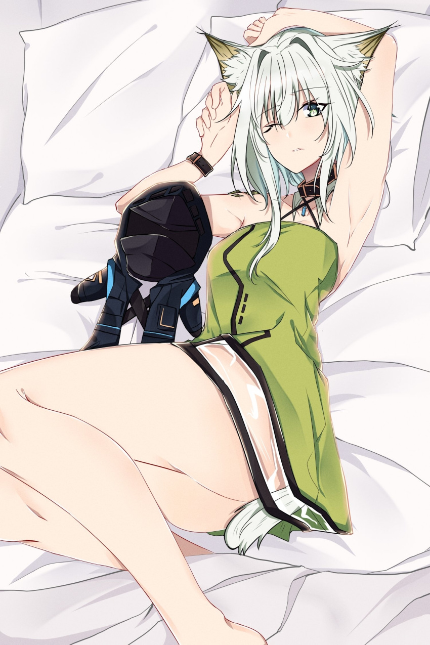 1girl animal_ear_fluff animal_ears arknights armpits arms_up bangs bare_arms bare_legs bare_shoulders bed black_choker breasts character_doll choker commentary criss-cross_halter doctor_(arknights) dress english_commentary eyebrows_visible_through_hair feet_out_of_frame green_dress grey_eyes hair_between_eyes hair_intakes halterneck highres kal'tsit_(arknights) looking_at_viewer lying on_back one_eye_closed ore_lesion_(arknights) pillow pokarii_zuu short_dress short_hair silver_hair small_breasts solo tail thighs wristband