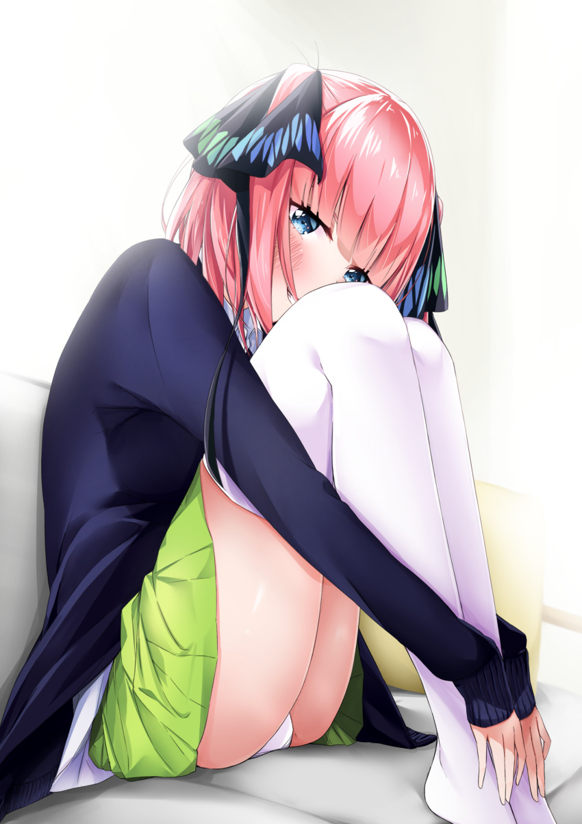 1girl blue_eyes blue_sweater blush go-toubun_no_hanayome green_skirt grin highres long_sleeves miniskirt nakano_nino panties pantyshot pink_hair pleated_skirt shiny shiny_hair shirt short_hair simple_background sitting skirt smile solo sweater underwear white_background white_panties white_shirt yumemo