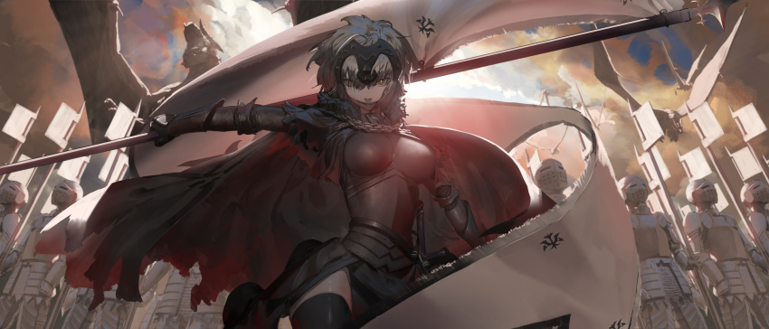 1girl absurdres armor armored_dress bangs banner black_cape black_dress black_legwear cape day dress fate/grand_order fate_(series) faulds from_below gauntlets grin hair_between_eyes highres holding jeanne_d'arc_(alter)_(fate) jeanne_d'arc_(fate)_(all) looking_at_viewer namusan1146 outdoors red_eyes shiny shiny_legwear shiny_skin short_hair silver_hair smile solo_focus thigh-highs torn_cape torn_clothes