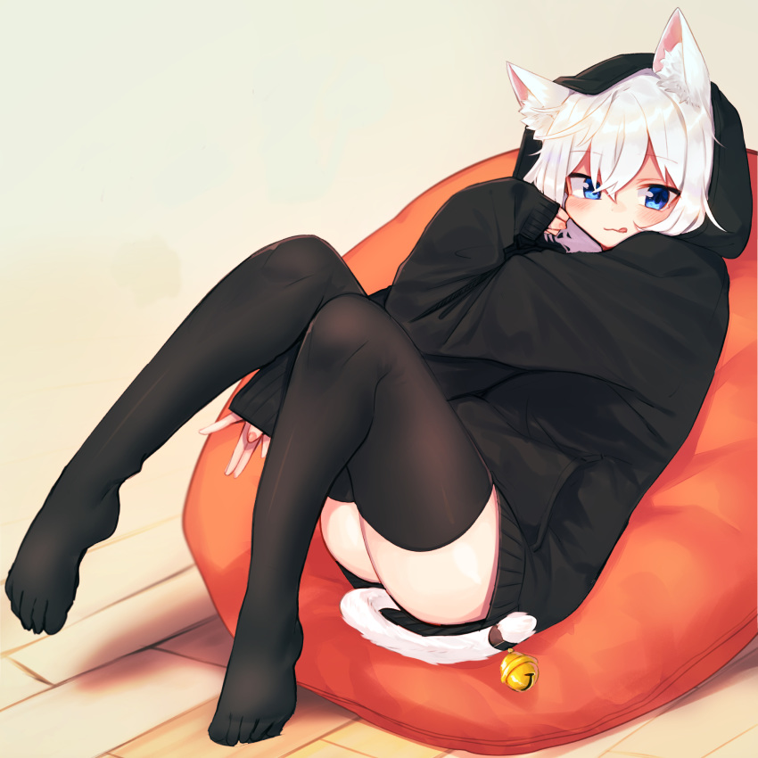 1girl animal_ear_fluff animal_ears ass bangs bean_bag_chair bell between_legs black_hoodie black_legwear blue_eyes blush cat_ears cat_girl cat_tail closed_mouth commentary daifukumochi_(akaaokiiwo) eyebrows_visible_through_hair full_body hair_between_eyes hand_between_legs highres hood hood_up hoodie jingle_bell knees_up long_sleeves looking_at_viewer no_shoes original red_nails sleeves_past_wrists solo symbol_commentary tail tail_bell thigh-highs tongue tongue_out white_hair wooden_floor