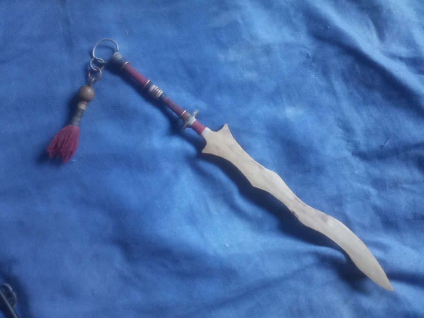 asian blade blue_background east etc highres moro photograph_(medium) south sword tassel weapon