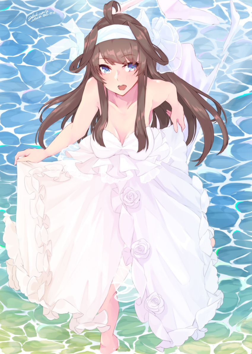 1girl ahoge alakoala alternate_costume brown_hair commentary_request dated double_bun dress dress_lift hairband highres kantai_collection kongou_(kantai_collection) long_hair solo strapless strapless_dress twitter_username violet_eyes wading water water_surface wedding_dress white_dress white_hairband