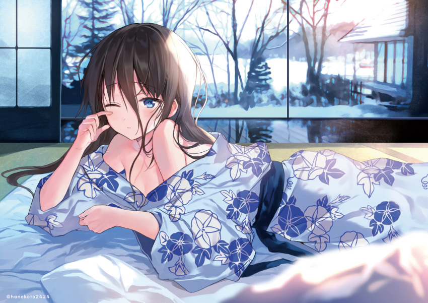 1girl bangs bare_shoulders bare_tree black_hair blue_eyes blue_kimono blush closed_mouth commentary_request eyebrows_visible_through_hair floral_print futon hair_between_eyes hanekoto indoors japanese_clothes kimono long_hair long_sleeves looking_at_viewer lying messy_hair morning off_shoulder on_stomach one_eye_closed original reflection reflective_floor solo tears tree waking_up wide_sleeves winter wiping_tears
