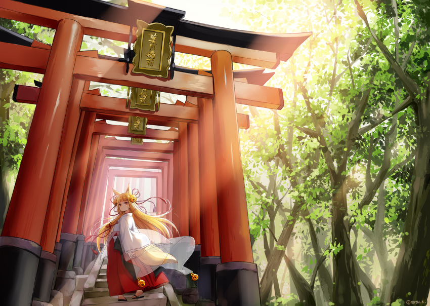 1girl animal_ear_fluff animal_ears back_bow bangs bell black_bow blonde_hair blunt_bangs bow commentary_request day expressionless forest fox_ears fox_tail hair_bell hair_ornament hakama hazuki_natsu highres japanese_clothes jingle_bell kitsune long_hair looking_at_viewer miko nature original outdoors red_eyes red_hakama ribbon-trimmed_sleeves ribbon_trim sandals solo stairs standing tail tassel torii twitter_username wide_sleeves