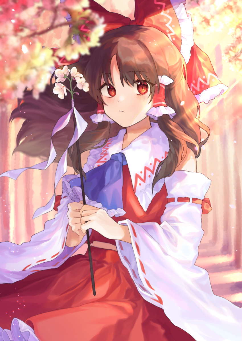 1girl absurdres blue_neckwear bow brown_hair cheunes commentary cowboy_shot day detached_sleeves flower gohei hair_bow hair_tubes hakurei_reimu highres holding light_rays long_hair long_sleeves looking_at_viewer outdoors red_bow red_eyes red_skirt red_vest skirt solo sunbeam sunlight touhou vest