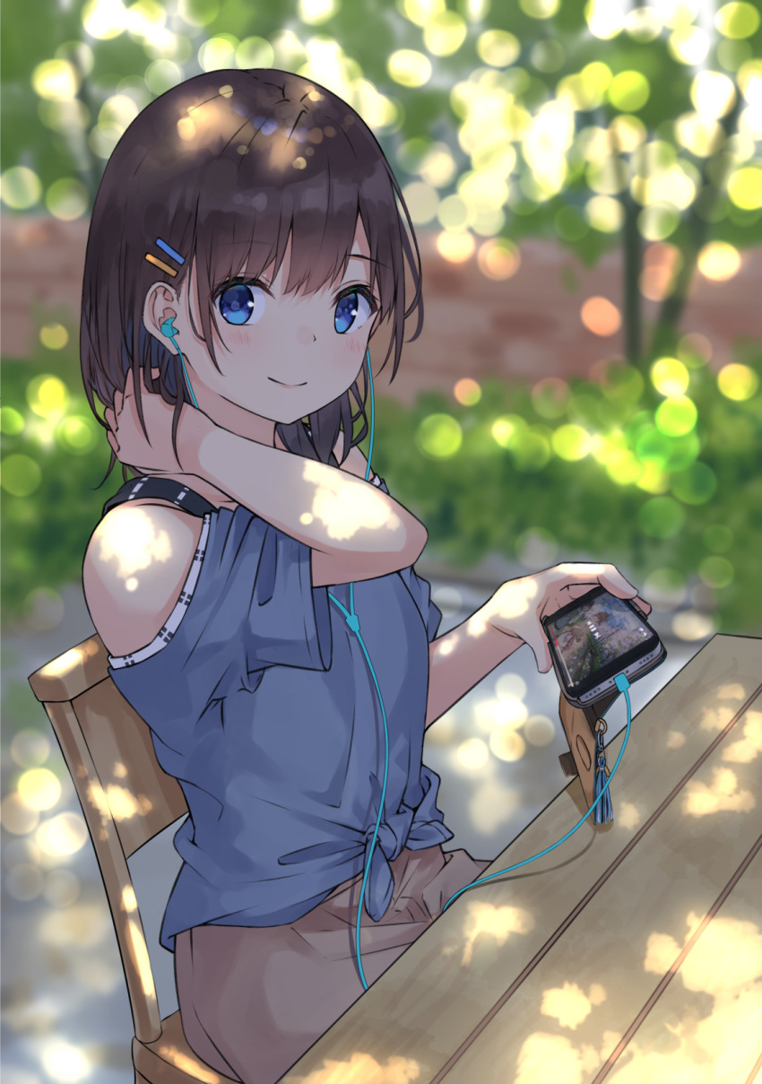 1girl bangs bare_shoulders black_hair blue_eyes blue_shirt blurry blurry_background blush brown_skirt cellphone chair closed_mouth commentary_request dappled_sunlight day depth_of_field earphones earphones eyebrows_visible_through_hair hair_ornament hairclip hand_up highres holding holding_phone looking_at_viewer miko_fly off-shoulder_shirt off_shoulder on_chair original outdoors phone shirt short_sleeves sitting skirt smile solo sunlight table wide_sleeves