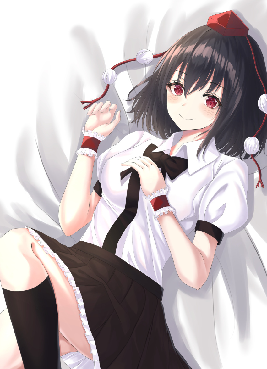 1girl absurdres arms_up black_hair black_legwear black_neckwear black_skirt blush bow bowtie breasts commentary eyebrows_visible_through_hair feet_out_of_frame gradient gradient_background hair_between_eyes hand_on_own_chest hat highres knee_up kneehighs kure:kuroha looking_at_viewer lying medium_breasts on_back petticoat pom_pom_(clothes) puffy_short_sleeves puffy_sleeves red_eyes red_headwear shameimaru_aya shirt short_hair short_sleeves skirt smile solo tokin_hat touhou white_shirt wrist_cuffs